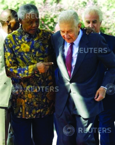 NELSON MANDELA WALKS WITH PRESIDENT EZER WEIZMAN IN JERUSALEM.